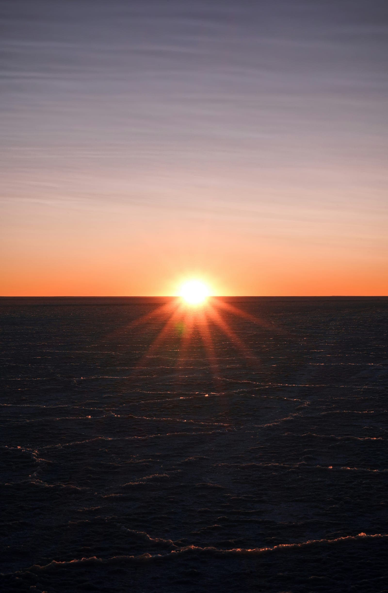 The sun setting over the sea